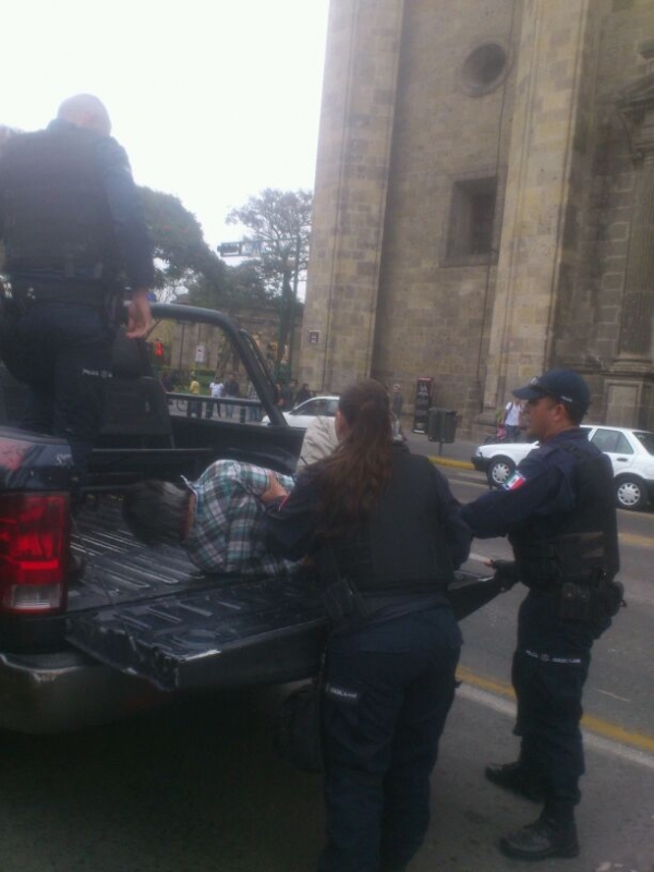 El vendedor ambulante Eugenio Marín, adulto mayor, siendo subido a la patrulla de policía de Guadalajara, GH-025