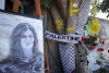 Cinta amarilla marca agujeros de bala en un árbol y un retrato y flores crean un memorial improvisado, en el lugar donde la periodista palestina-estadounidense de Al-Jazeera Shireen Abu Akleh fue asesinada a tiros en la ciudad cisjordana de Jenin, el 19 de mayo de 2022 El ejército israelí reconoció por primera vez el lunes 5 de septiembre de 2022 que uno de sus soldados probablemente mató a la veterana periodista de Al Jazeera Shireen Abu Akleh en mayo, y dijo que su propia investigación muestra que le dispararon por error y que nadie lo hará. afrontar el castigo.