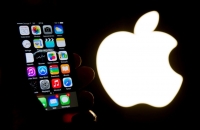 Imagen de un iPhone frente al logotipo de Apple